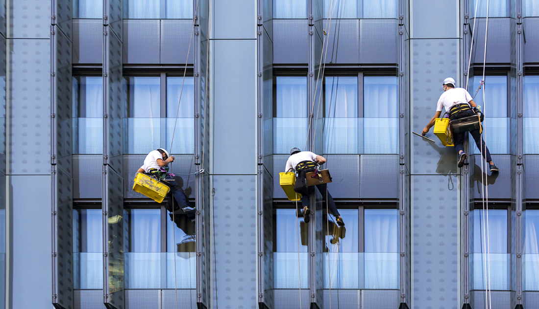 industrial climber cleans windows