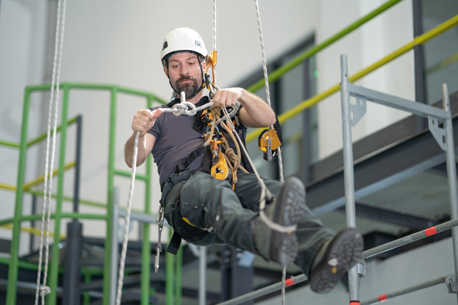 man on a rope hanging banner